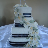 Calla Lilly Wedding Cake hand made calla lilies! I loved making these. They are super easy! Buttercream icing cake with real ribbon. Thanks for looking.
