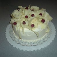 My_Cakes_022.jpg this is a white chocolate cake with a buttercream raspberry filling. Iced with Buttercream, shaved white chocolate and raspberries on top....