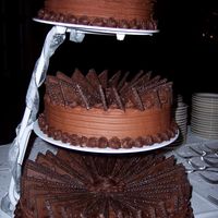 Wilton Groom's Cake Orange Cheesecake, with Chocolate Buttercream. I need more practice with frosting. I wasn't happy with the way I combed the sides. I...