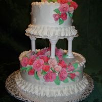 My First Wedding Cake This was a yellow cake with buttercream frosting. I made the fondant roses in 3 shades of pink and scattered white fondant flowers across...
