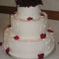 3 Tier Rose Petal This cake has buttercream frosting with white on white scroll work and silk rose petals, and hand made rose topper.