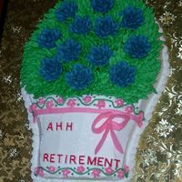Flowers For Retirement This was my take on an idea from one of the Wilton yearbooks. It's all BC icing and the flowers are made from royal icing