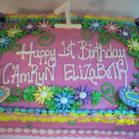 Camryn Elizabeth's 1St Birthday 1/2 sheet milk chocolate with french vanilla bc. Daisies, ladybugs and butterflies are fondant. RI #1. Entire cake dusted with super pearl...