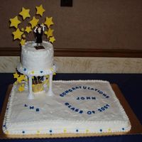 Graduation Cake Vanilla cake frosted with wilton whipped icing mix (their version of whipped cream icing that is stable in warm weather...this cake was for...
