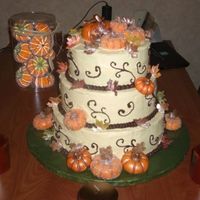 Fall Themed Wedding Cake This cake has has ivory buttercreme icing, chocolate buttercreme border and scroll decor, fondant pumpkins brushed with gold and bronze...