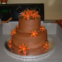 Chocolate Wedding Cake With Deep Orange Lily's This was my Course III Cake that I completed in class. I had a lot of fun with the flowers. I used a 10in and a 6in white cake with...