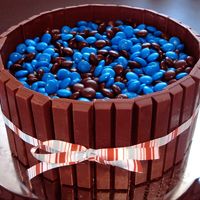 Kitkat Barrel Cake 2-8" white cakes with Doctored Buttercream Dream. Covered with what else....kit kat bars and M&M's! This is for my husbands...