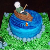 Fishing Fruit cake. I painted the water and grass using Wilton gel colours and some vodka. Icing man fishing. This was Dad's 60th Birthday...