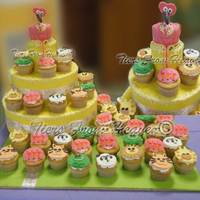 Olivia's Flamingo Cupcake cake for Birthday at the zoo. The animals are a cute panda, lion, tiger, turtle and giraffe. The main cupcake is shaped like a...