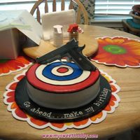 Birthday Target And Gun single layer 9" round iced in buttercream. WHEW....those concentric circles were fun. :) Edible image cut out of 50/50 fondant/...
