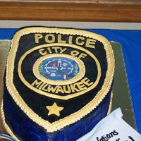 My Brother's Graduation From The Police Academy Four tiered downy cake with guava curd, chocolate ganache, and guava buttercream filling. Cake is covered in fondant.