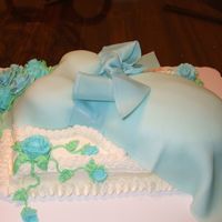 Baby Boy Baby Shower This was a marble cake, filled and covered in buttercream. Dress and ribbon made of fondant. Thanks Cake Central for your fondant bow...