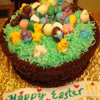 Easter Basket Chocolate easter basket with chocolate eggs and bunnies on top of green colored coconut flakes. Made a handle out of fondant but didn'...
