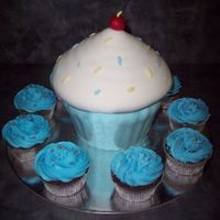 Giant Cupcake Giant cupcake and normal size cupcakes made for 1st birthday of my godson. Little cupcakes are chocolate mud...giant cupcake is Cowboy...