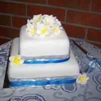 Frangipani Wedding 2 tier banana and choc mud cakes covered with fondant with gumpaste frangipanis.....