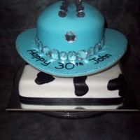 Like A Rhinestone Cowboy... Banana mud cake covered with fondant for both cakes...1 inch pillars in between to seperate the two cakes and purchased rhinestones to...