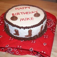 Cowboy Theme This is one of my very first cakes made for a friend. Iced in buttercream and the hats and boots are chocolate candies I made in molds. I&#...
