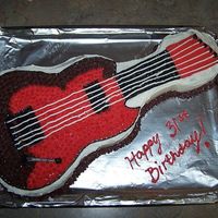 Electric Guitar Cake This is my VERY FIRST CAKE!! I made this for my husband whom LOVES guitar, not to mention Guitar Hero (lol!) I made it with Wiltons guitar...