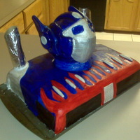 Transformers B-Day Cake Tried my best, but I made this cake for an uncle of mine who loves Optimus Prime. The head is made out of styrofoam and covered in gumpaste...