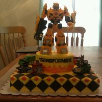 Transformers Bumble Bee Cake Chocolate cake with cookies n cream filling covered in buttercream with fondant accents.