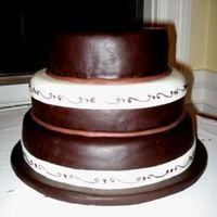 White And Dark Wedding Cake Alternating layers of vanilla sponge cake with hazelnut buttercream and chocolate sponge with chocolate mousse filling. The cake is covered...