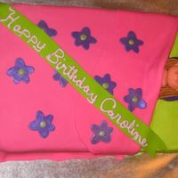 Sleep Over Birthday Cake This cake was for a sleep over birthday party. The cake was done in buttercream and fondant. The little girl is also made out of fondant.