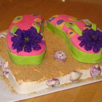 Flip Flop Cake Flip flops are cake covered with mmf and sea shells are candy molds. I added the sand using graham cracker crumbs,