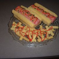 Hot Dog & Fries This was really easy - loaf pans with the center cut out & reserved for the fries. I used little roll donuts...like Hostess Cakes - two...