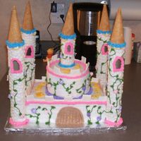 Princess Caslte I made this for my daughter's 3rd birthday. The towers are paper towel rolls covered in royal icing with a 12 tip...then I smooshed it...