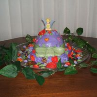 Tinkerbell Hat Cake I made a hat...sort of, with a fondant bow that didn't want to quite stay. And then covered it with lots of royal icing flowers made...