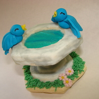 Birdbath Cookie Stack A stack of butter cookies, covered with cookie icing with buttercream smudges for two-tone concrete effect. The top cookie is a "...