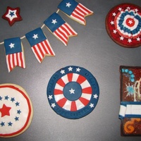 Independence Day Cookies Made for the cookie club. Decorated with fondant and cookie icing and sanding sugars. The banners are baked onto a food-safe twine.