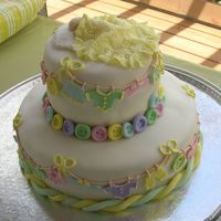 Baby Laundry Two tiered stacked cake with baby clothes attached to a close line. There is a sleeping baby on top.