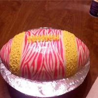 Pink Football For a birthday party on Superbowl Sunday! Rolled fondant, hand painted pink zebra stripes, and yellow buttercream.