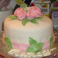 Roses.jpg This is a champagne cake with strawberry filling and covered in fondant.Flowers were made in fondant too.