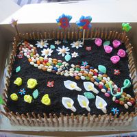Garden Cake I made this cake for my grandmother's 82nd birthday. She loved it. It is a yellow cake with bc icing and crushed oreos for the dirt....