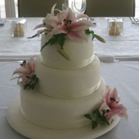 Pink Lily Wedding Cake This was my nephews wedding cake, ivory iced cake and board, pink lilies and roses. Chocolate mud, white mud and butterscotch mud cakes. I...