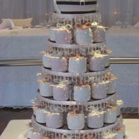 Mini Cakes With Bows 90 round mini cakes with gumpaste bows and a 6" top cake. The cakes were chocolate mud, white chocolate mud and butterscotch mud. A...