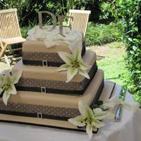 Outside Wedding I really liked this cake simply but effective. All white chocolate mud cake. Gumpaste lilies with small white roses. Monogram topper set in...