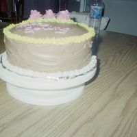 Practice Ckae Two layer yellow with chocolate icing between layers and on top and all around the cake.