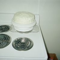 Orange Cake Two layer orange cake with pineapple cool whip frosting between the layers and on top and sides.