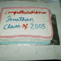High School Graduation Half sheet chocolate cake with buttercream icing. Color of decors reflects school colors.