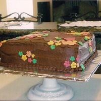 First Chocolate Cake With Fondant Flowers This is my first cake ever. Buttercream is delicious but looks sloppy! First time working with fondant flowers.