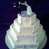 Debbies_Wedding_Cake.jpg iced with all buttercream . The flowers are fondont with pearl dust.