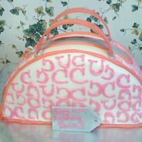 Coach Purse 12 inch round cut in half covered in fondant.