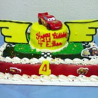 Lightning Mcqueen I wanted to make the top cake look like the top of the piston cup but the wings were just way too big!! It didn't turn out like I saw...