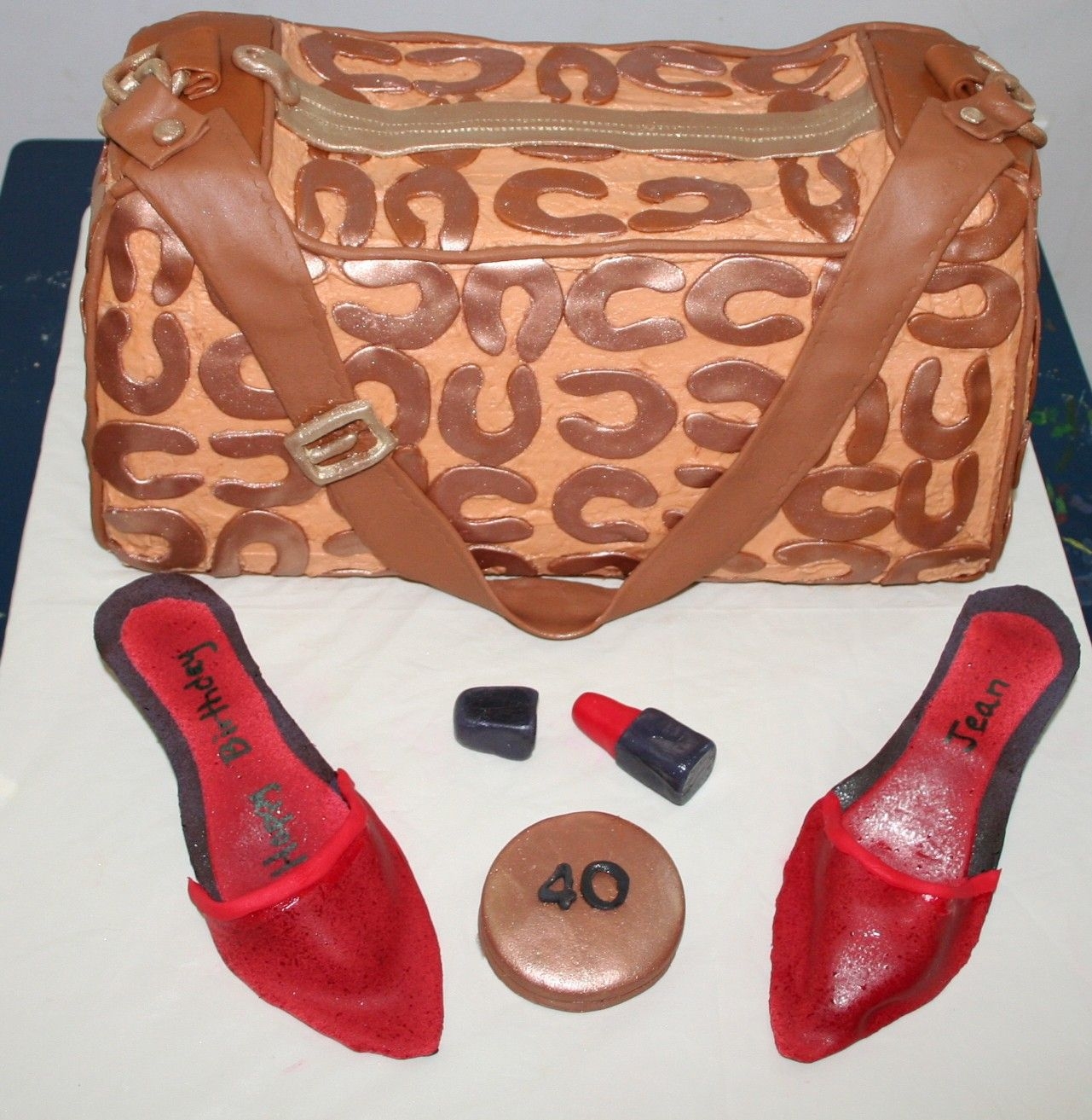 Coach Bag With Red Shoes Buttercream icing with fondant accents. Shoes and accesories are fondant