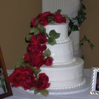 Red Roses Per Brides request roses are fake - she wanted to be able to reuse them. Cool idea! White cake w/ buttercream icing - this is the 1st...