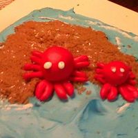Crab Birthday Cake Dark chocolate cake with buttercream. Crabs are made out of fondant with brown sugar "sand."