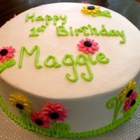 Daisy Birthday French vanilla cake with vanilla buttercream decorated with 'electric' yellow and pink gumpaste daisies. Thanks for looking!